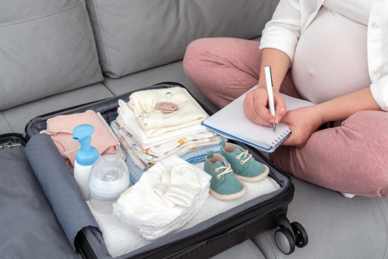 neatly packed maternity hospital bag on a bed, featuring baby clothes, diapers, maternity pads, and a baby blanket, ideal for a Kenyan mom preparing for delivery.
